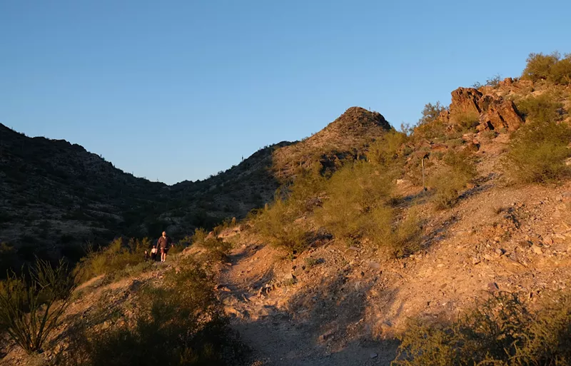 Image: Hikers walk along the trail inside the Phoenix Mountain Preserve nearby the Piestewa Peak Recreation Area.